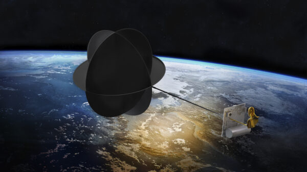 A satellite with an object floating above the Earth.