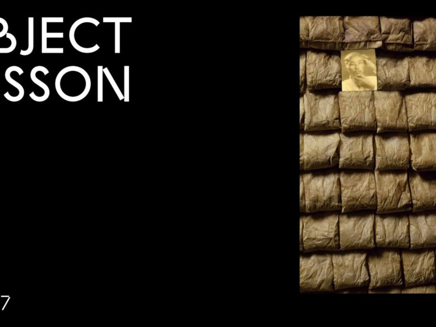 A black rectangle with the words Object Lesson in the upper left hand corner and OL 017 in the bottom left hand corner accompanied by an image on the right hand side of rows of tea bags interrupted by one portrait in the second row