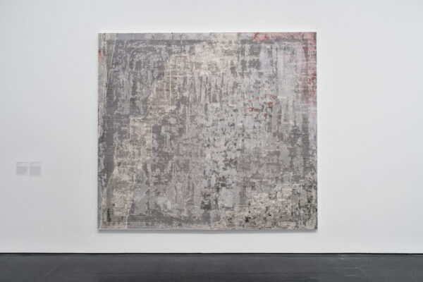 A single square abstract painting featuring mostly black and white colors hangs on a white wall.