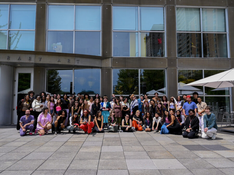 A group of people pose in front of the Museum of Contemporary Art Chicago.