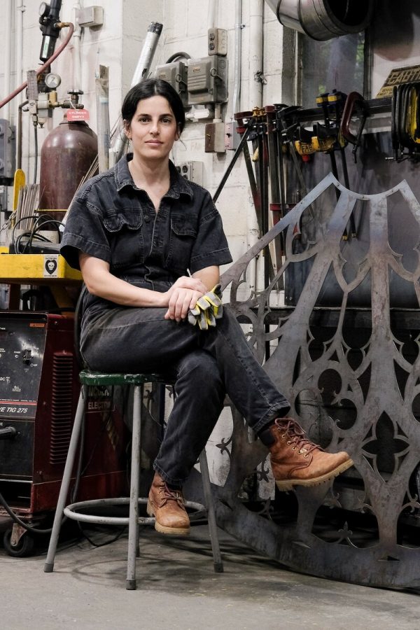 Portrait of an artist sitting in their gallery