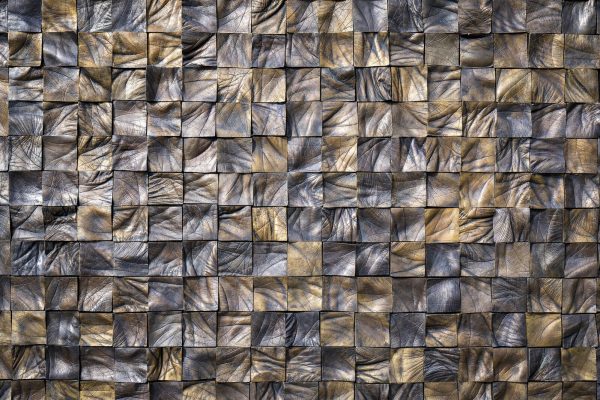 Wrinkled squares of different colored browns and tans arranged in a tight grid