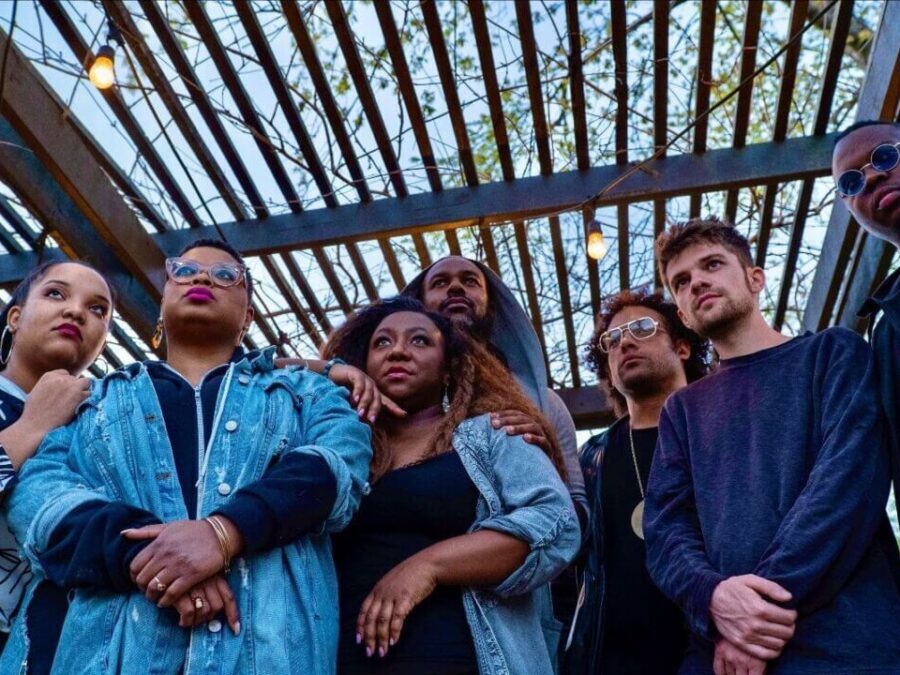 A seven-person band photo taken from the ground up