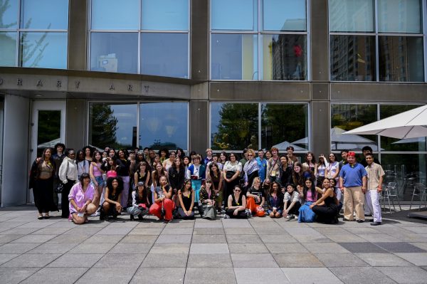a group of people poses on the terrace in front of the MCA