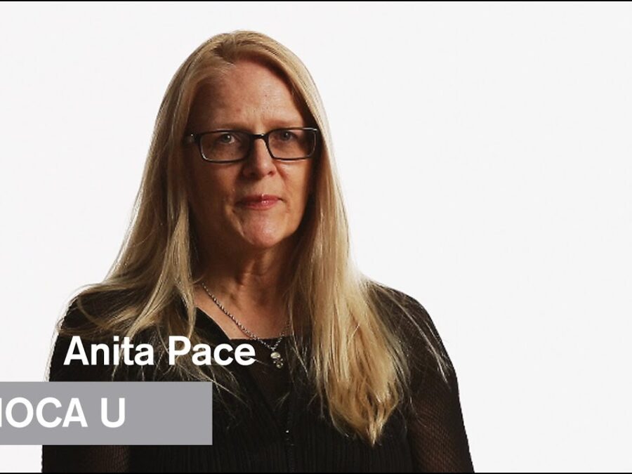 A female presenting person with ivory skin, long blond hair, and glasses against a white background. Overlaid on top of the image is white text reading Anita Pace and a grey rectangle with white text reading MoCA U