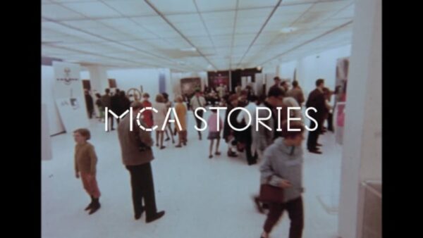 An archival photo of a gallery full of people with white text over it reading MCA Stories