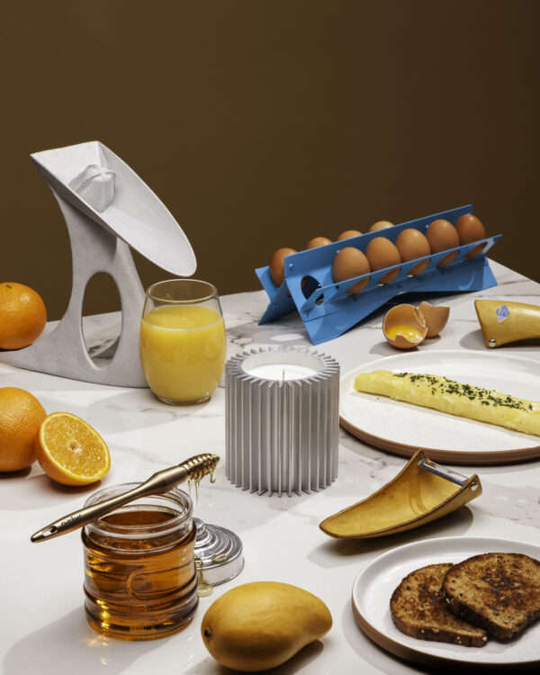 A table set for breakfast with fresh orange juice, eggs, honey, and toast