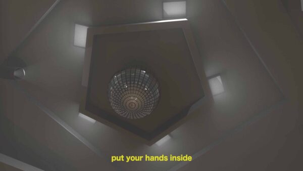 View up towards a ceiling in a dimly lit room with a large chandelier in a pentagon dropdown ceiling with rectangular lights on each side. A closed caption in yellow font reads put your hands inside.