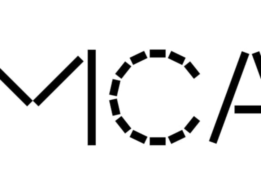 Black stencil font reading MCA against a white background. The M and A use long dashes, the C uses short dashes.
