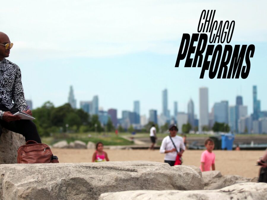 A male-presenting person with dark skin sits on a rock at a beach with Chicago's skyline in the background. Black text above reads Chicago Performs.