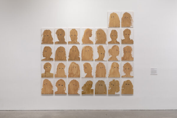 4 by 7 grid, with two extra at the top right, of headshots painted fully beige with added eyes
