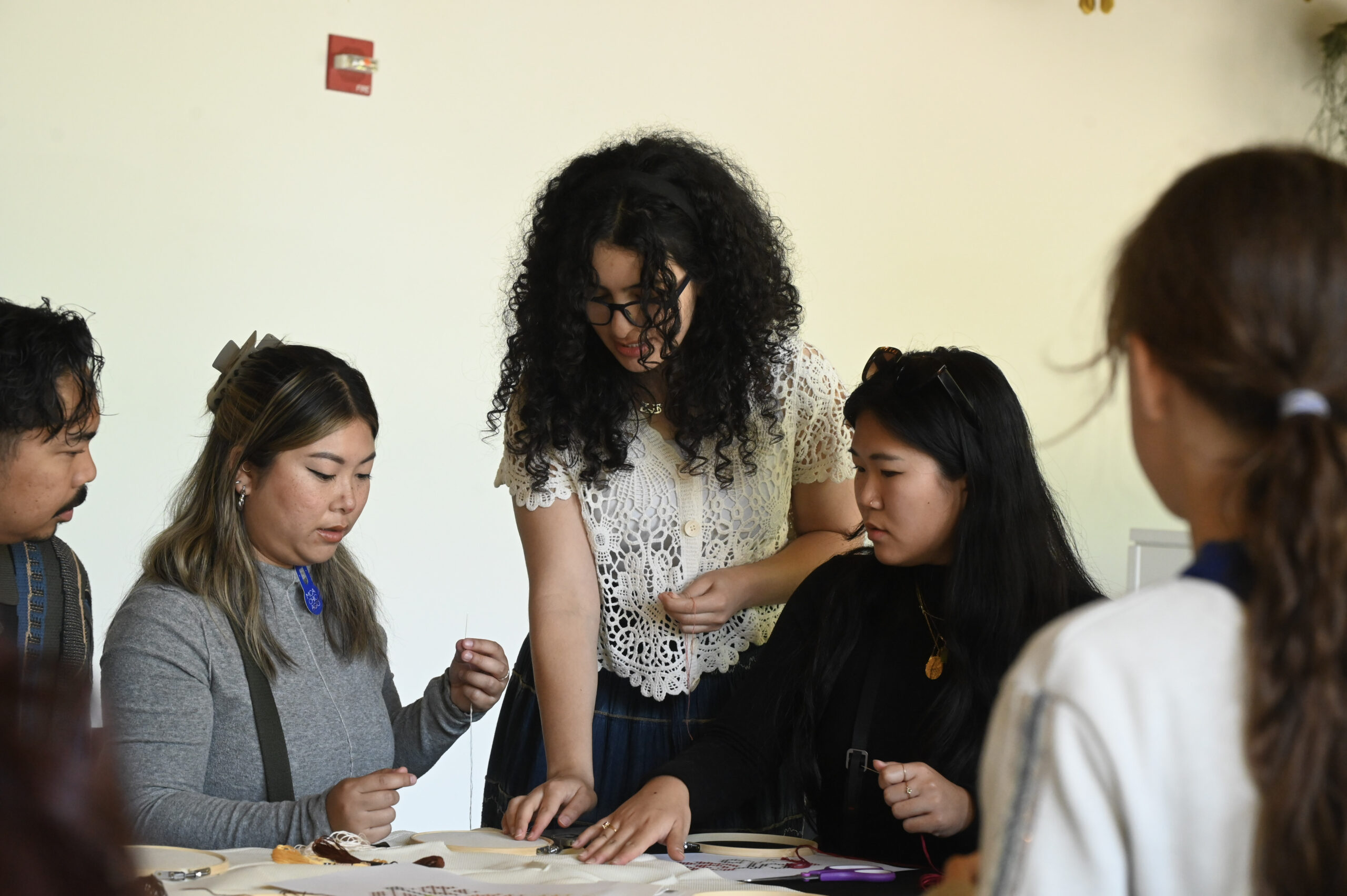 A group of teens work on a project together