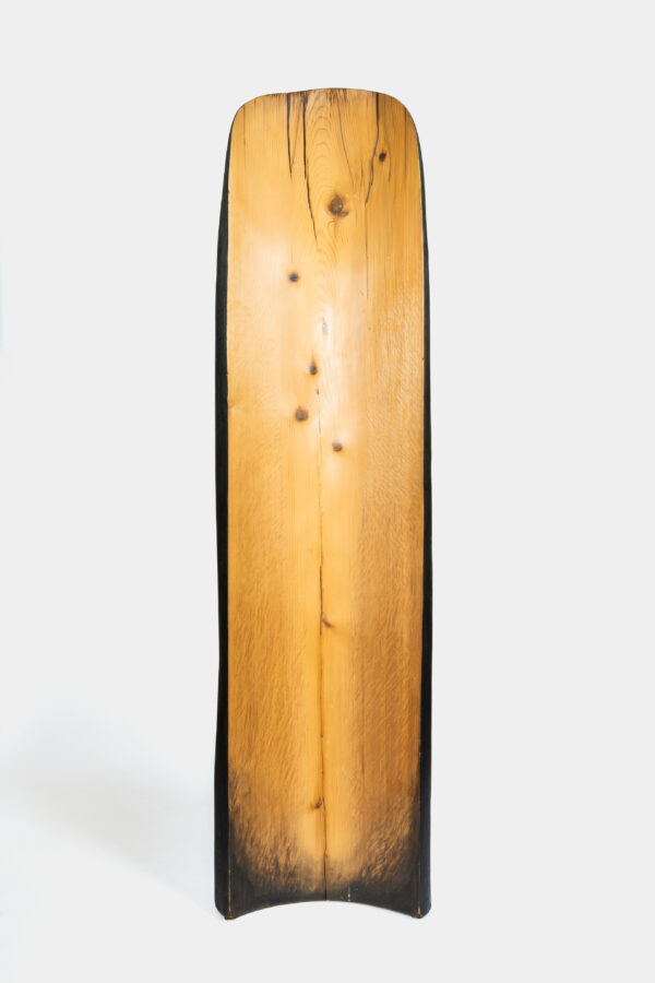 A long slab of golden wood shaped into a parallel curve on either end