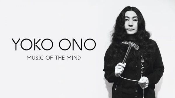 Yoko Ono holds a hammer next to black text reading Yoko Ono Music of the Mind