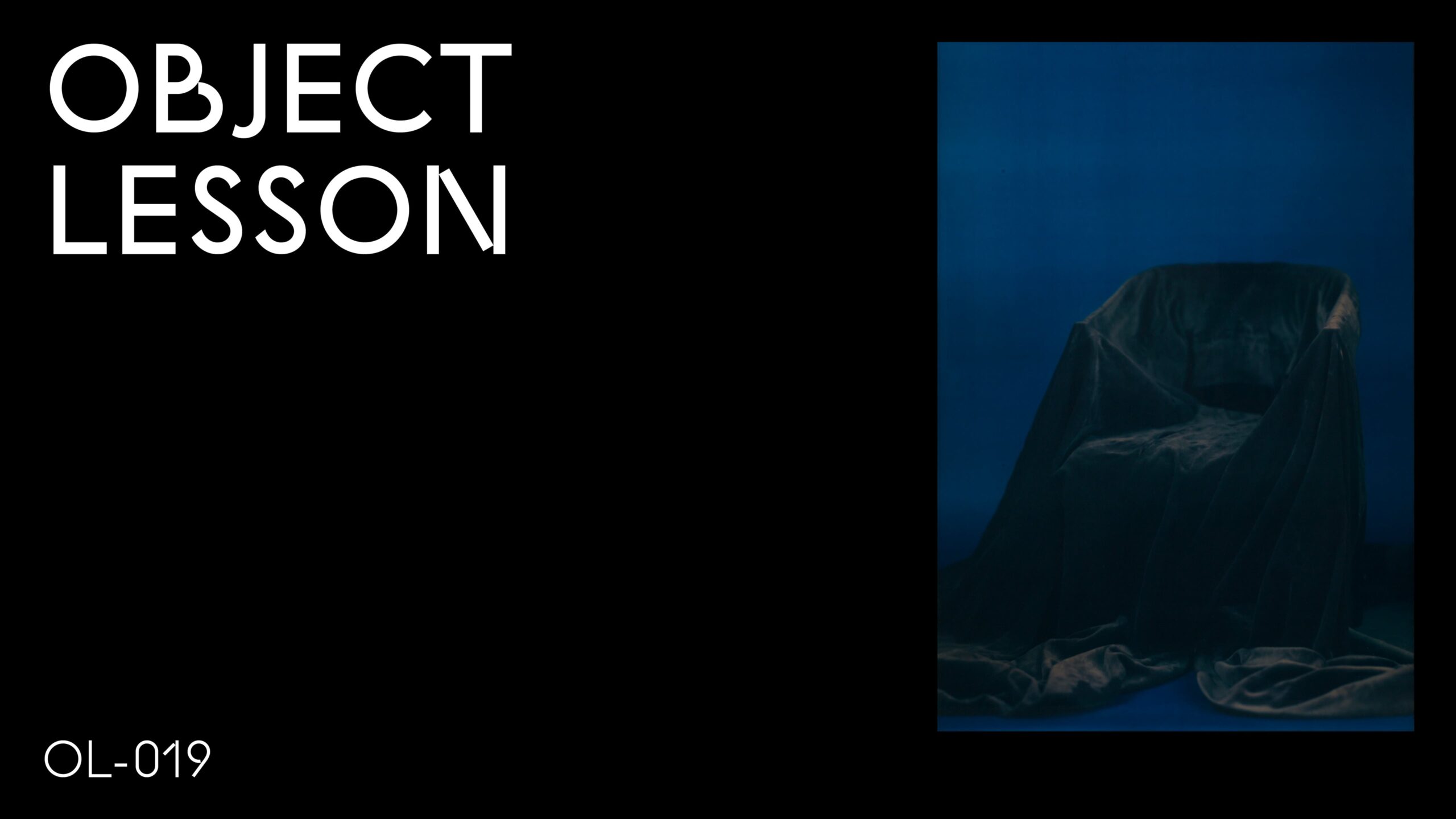 A black rectangle with the words Object Lesson in the upper left hand corner and OL 019 in the bottom left hand corner accompanied by an image of an empty chair in a blue room in the upper right hand corner
