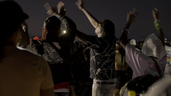 A crowd dancing in a dark space