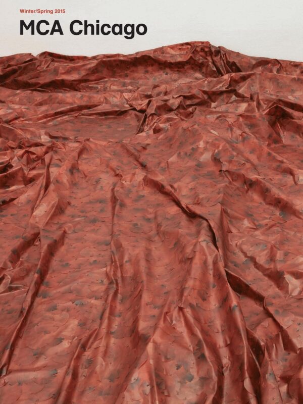 Cover of the MCA Chicago magazine for Winter Spring 2015 featuring a rusty red fabric spread out with several folds