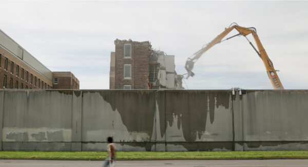 A crane over a wet concrete wall