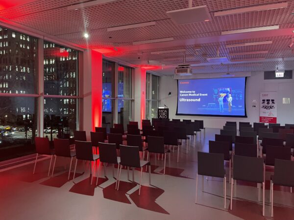 Red uplighting provides a dramatic atmosphere in a small room set up for a presentation