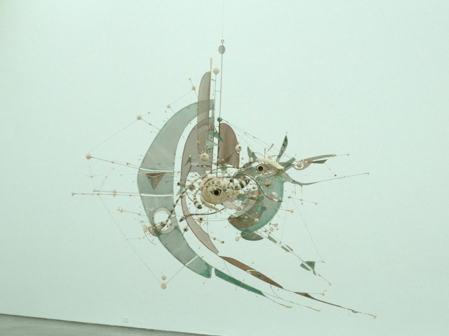 A suspended mixed-media sculpture with wire and steel sheets