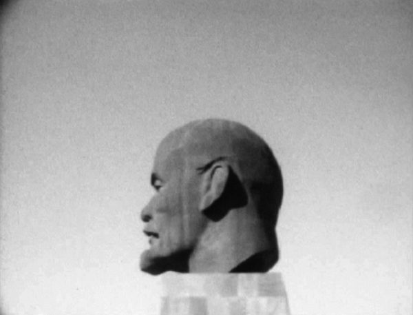 Black and white image of a large bust of a man viewed in profile