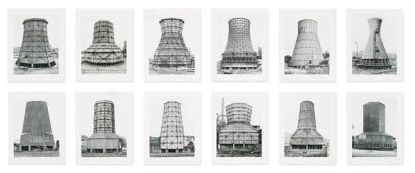 Two rows of six black and white images of large cylindrical chimneys
