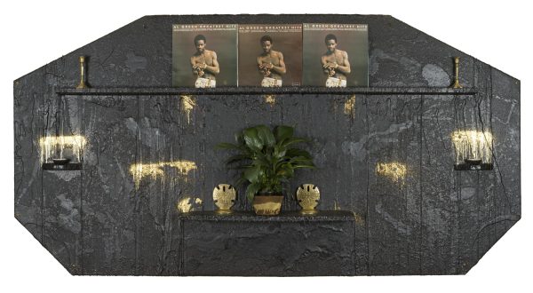 Installation with shelves containing plants, three Al Green albums, brass candlestick holders, and more