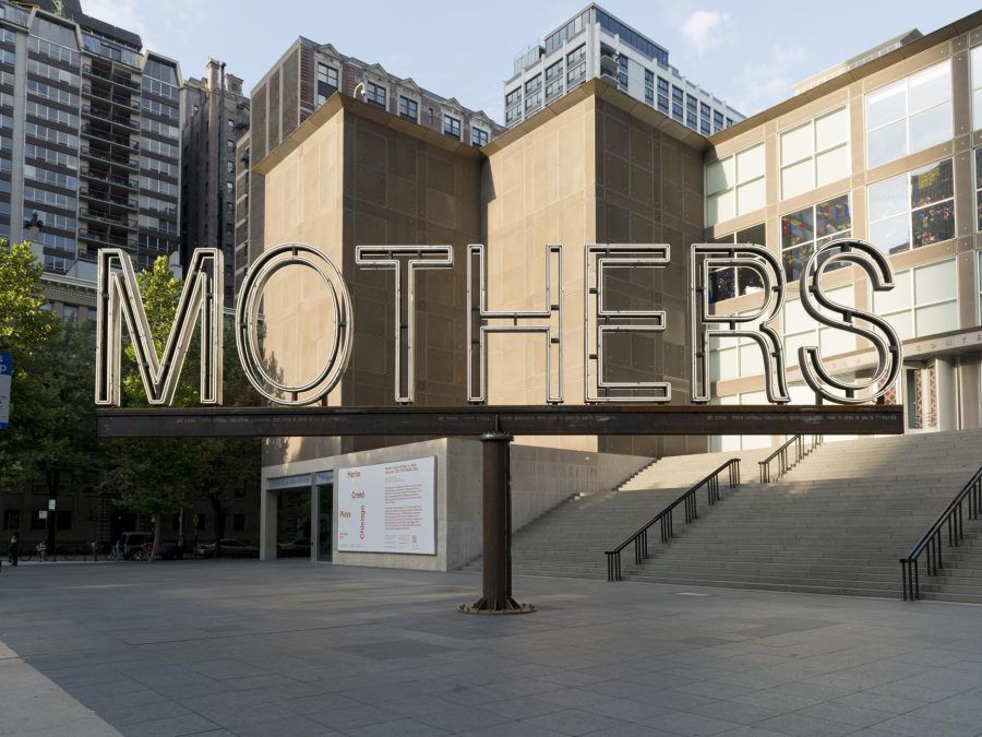 A white neon and steel sign says 