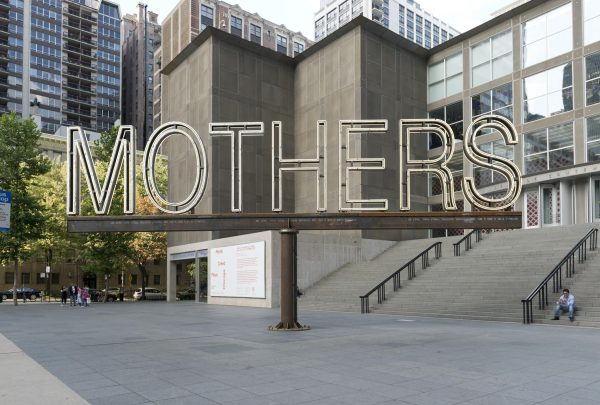 The word mothers spelled out in neon letters on a large metal stand on the MCA plaza