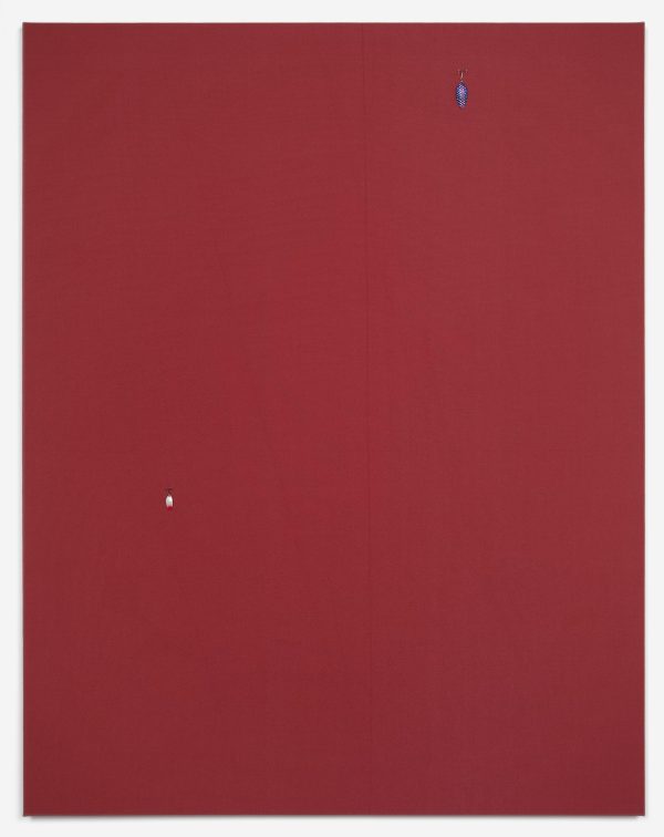 A large maroon rectangle has a small blue fishing lure attached towards the top edge of its left side. A small white fishing lure is attached to its lower right side.