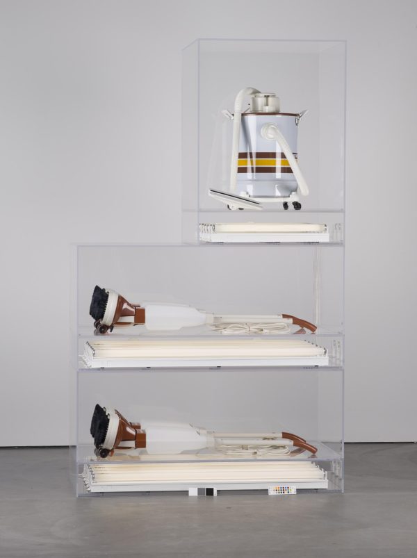 Three vacuums in display boxes stacked on top of each other. The bottom two are the same; the top vacuum is smaller