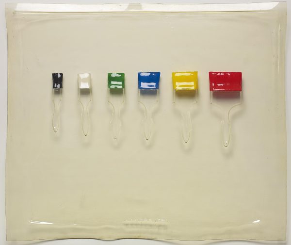 Clear impression of six paintbrushes that increase in size from left to right. Each has a different color for the bristles: black, white, green, blue, yellow, and red.