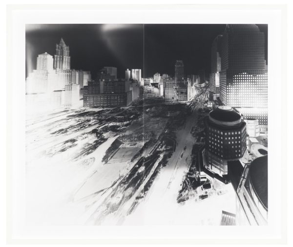 A black and white image of a construction site in a city with the contrast adjusted so that the highlights are overexposed and the shadows are deep and dark.
