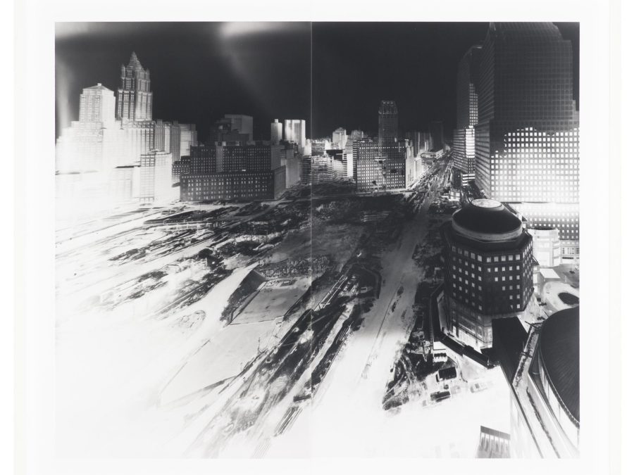 A black and white image of a construction site in a city with the contrast adjusted so that the highlights are overexposed and the shadows are deep and dark.