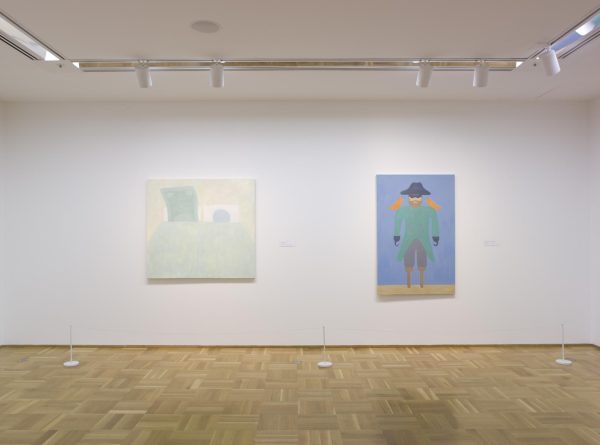 Gallery with two paintings hanging on a white wall