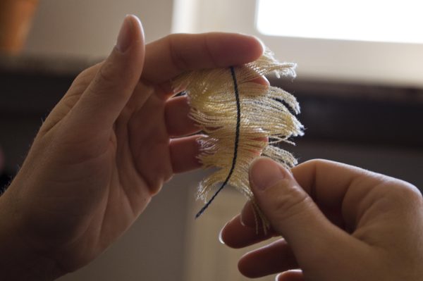 Two hands pull apart a piece of fabric