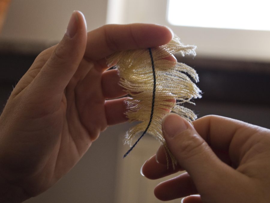 Two hands pull apart a piece of fabric