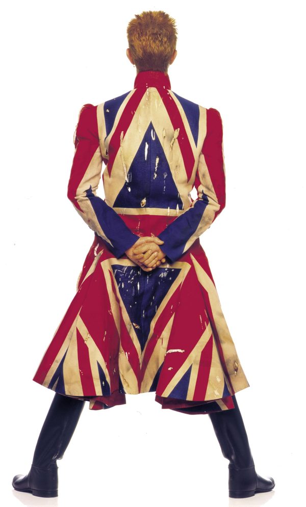 Back side of David Bowie wearing a coat featuring the British flag.