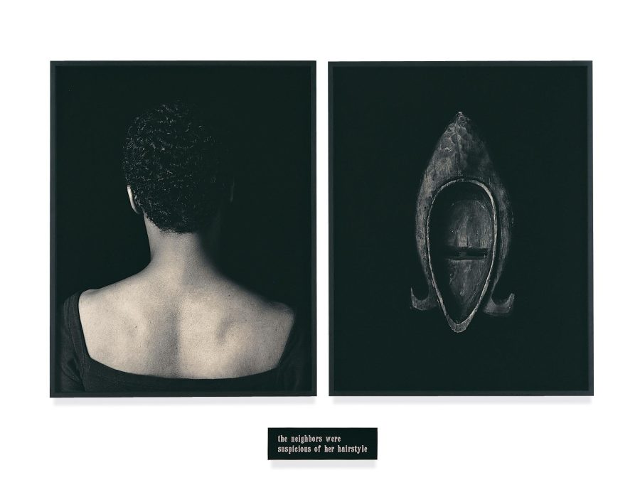 Two framed black and white pictures. The one on the left features a portrait with the person's back turned toward the viewer; the right image is of the back of a wooden mask. A small plaque appears under the frames.