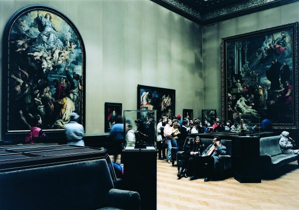 People gathered in a art gallery filled with Renaissance art