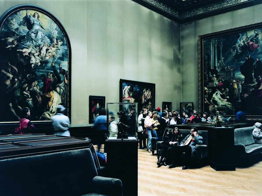 People gathered in a art gallery filled with Renaissance art