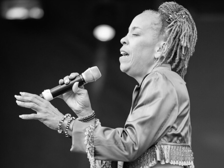 Black-and-white full-length photo of Maggie Brown singing