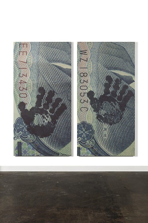 Two nearly identical images of a closeup of a USD bill's routing numbers and a handprint, but the hand print is in different places and the routing numbers of different