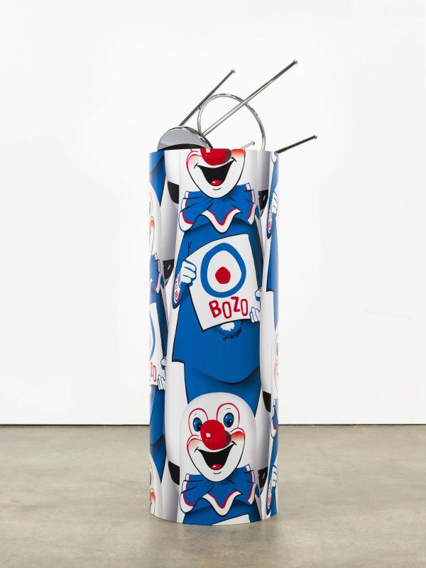 A cylinder is wrapped with the repeating image of a white, red, and blue clown holding a target with 