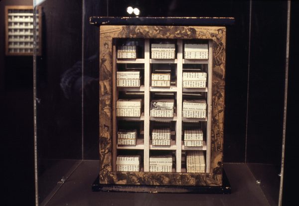 A framed three by five grid in a dark room
