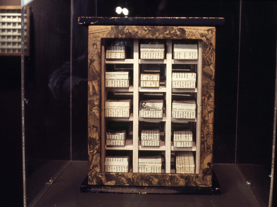 A framed three by five grid in a dark room