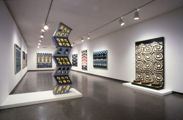 Artworks on the white walls of a gallery, some that extend to the floor