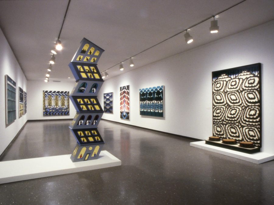 Artworks on the white walls of a gallery, some that extend to the floor