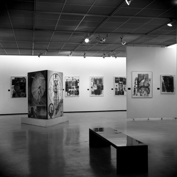 Black-and-white installation view of graphic artworks that appear collaged