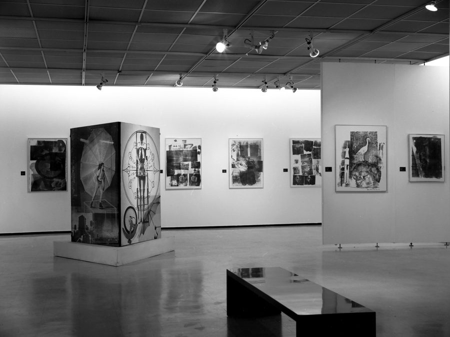Black-and-white installation view of graphic artworks that appear collaged